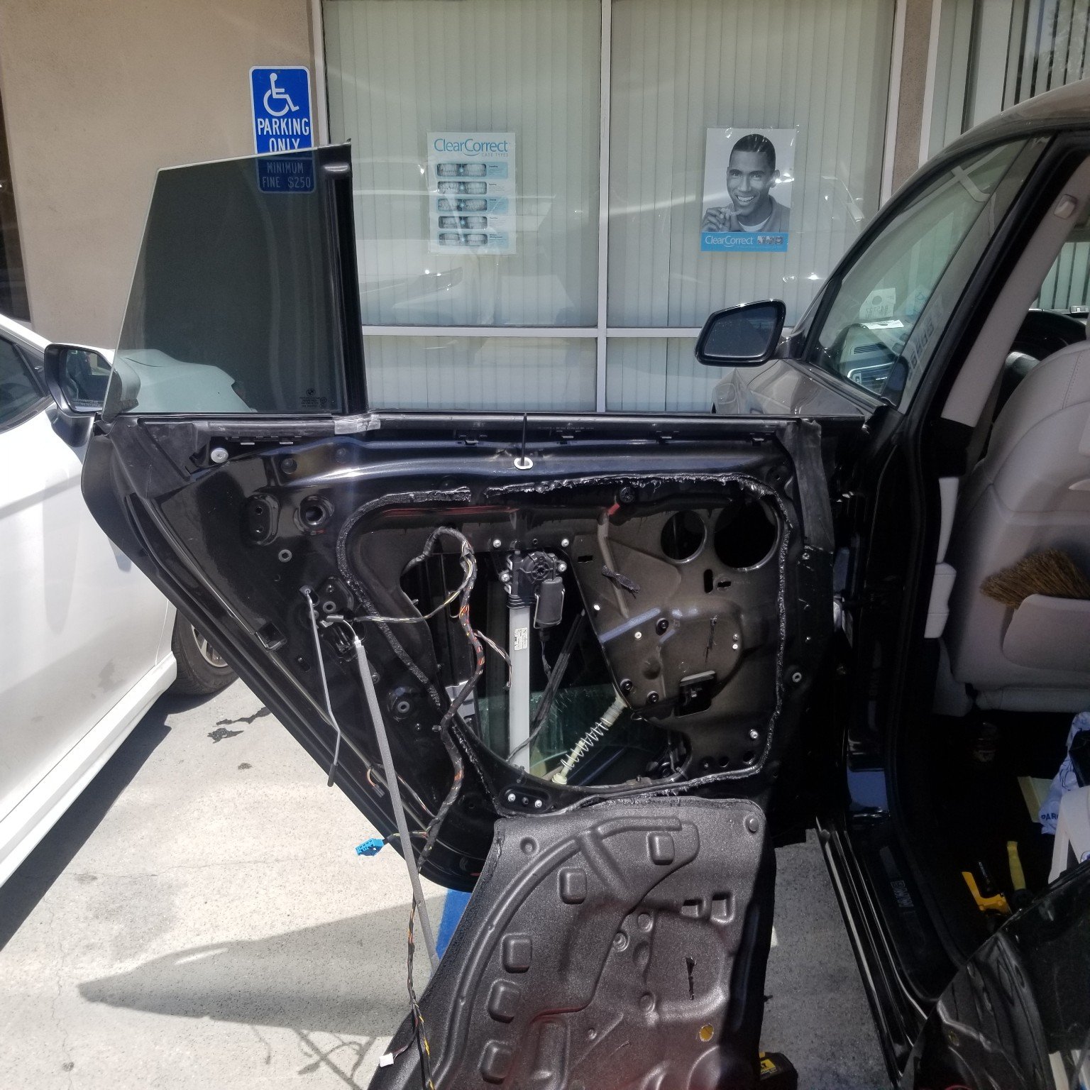 Vehicle door opened to expose its power window mechanism and glass